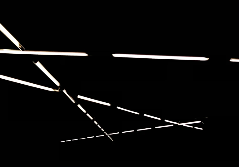 a black and white po of three lights and two sticks