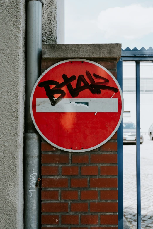 graffiti painted on the side of a red brick building