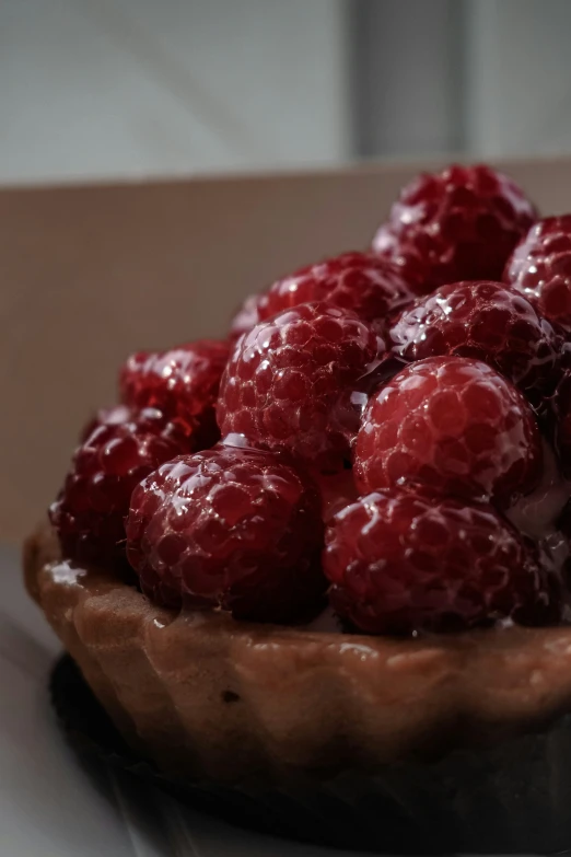 fresh raspberries are sitting in the pie crust