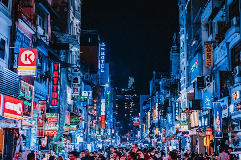 many people walking around a city street at night