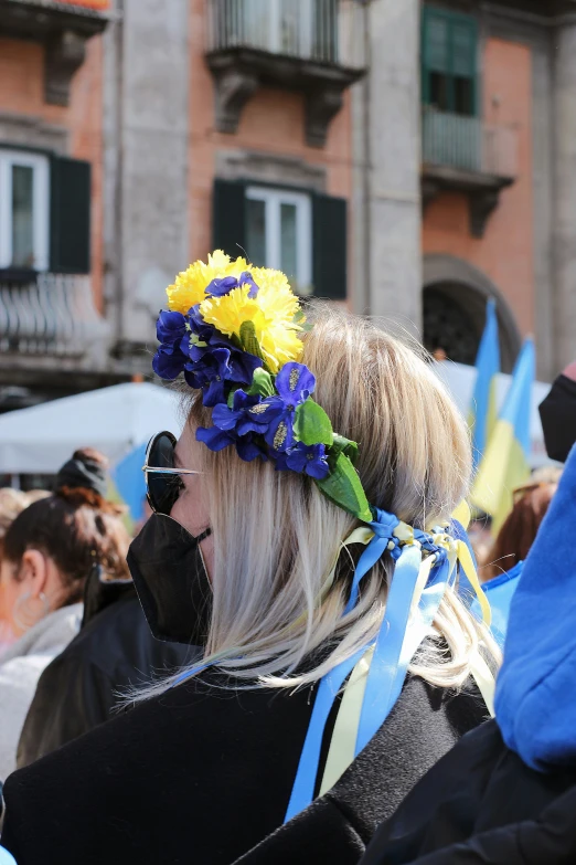 a woman wearing flower headbands in front of an old building