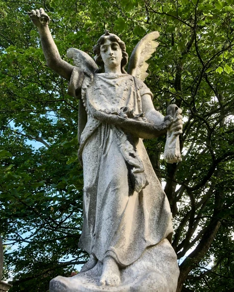 a statue of an angel sitting on top of a pedestal