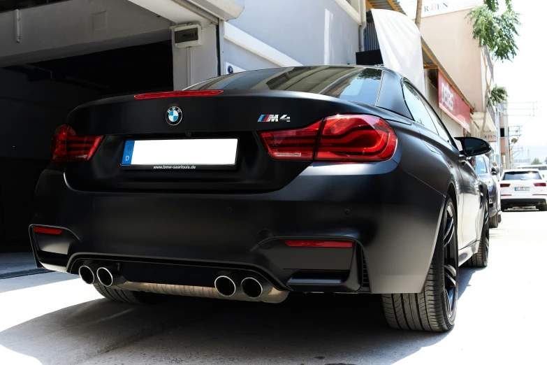 the rear view of a black bmw m6