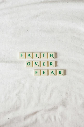 two scrabble - type words spell out faith over fear