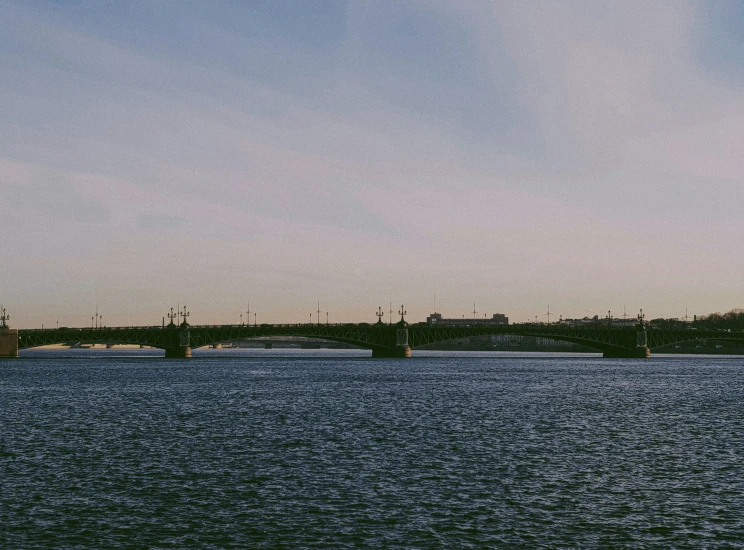 two ships in the middle of the ocean and a bridge above it