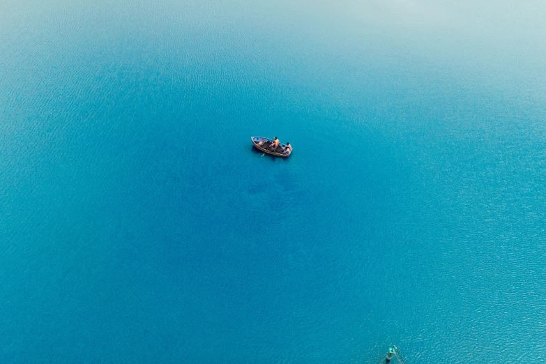 a small boat on the blue ocean