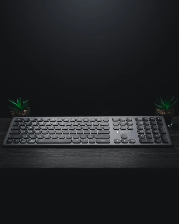 a small keyboard on a table in a black room