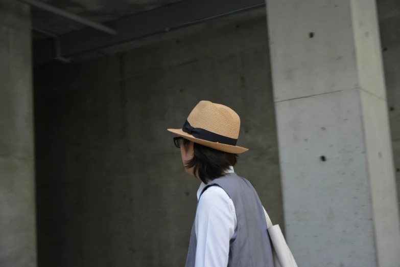 a person in a hat and vest is walking