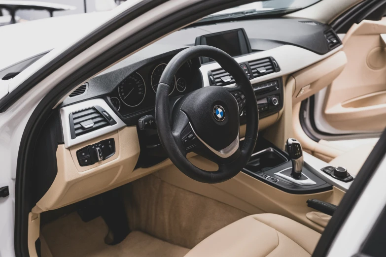 the interior of a car with steering wheel and dashboard