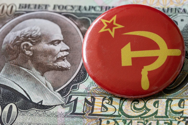 the communist president pin is sitting on some currency