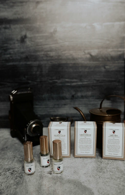 bottles of white substance and gold flasks on grey background