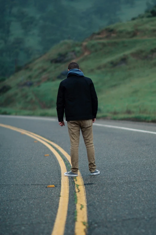 a man riding a skateboard down the road