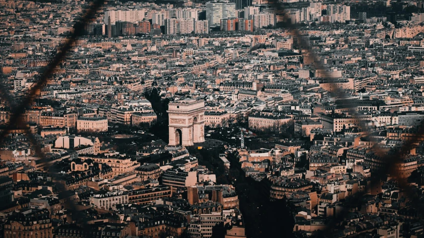 the city with buildings is seen through the telescope