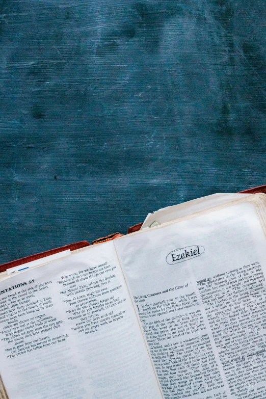 two open books on top of a blue table