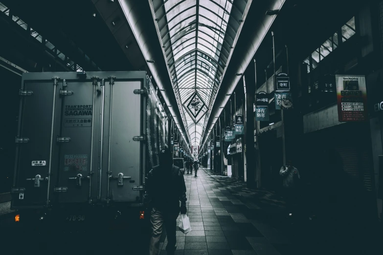 a person is walking down a long alley way