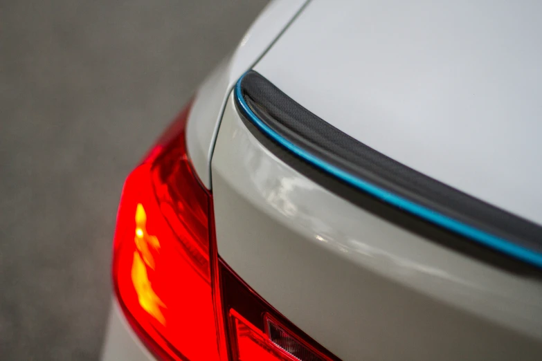 the back end of a car with bright blue lines