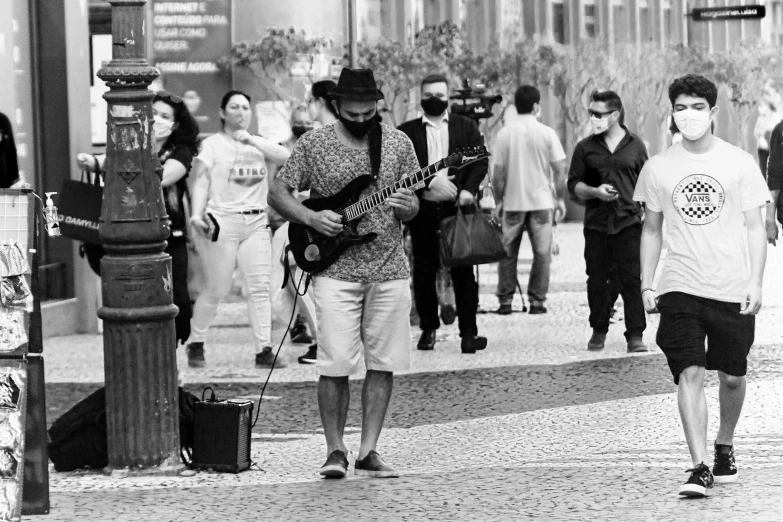 several people walking in an open city area