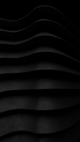 a dark room with wavy black foam walls