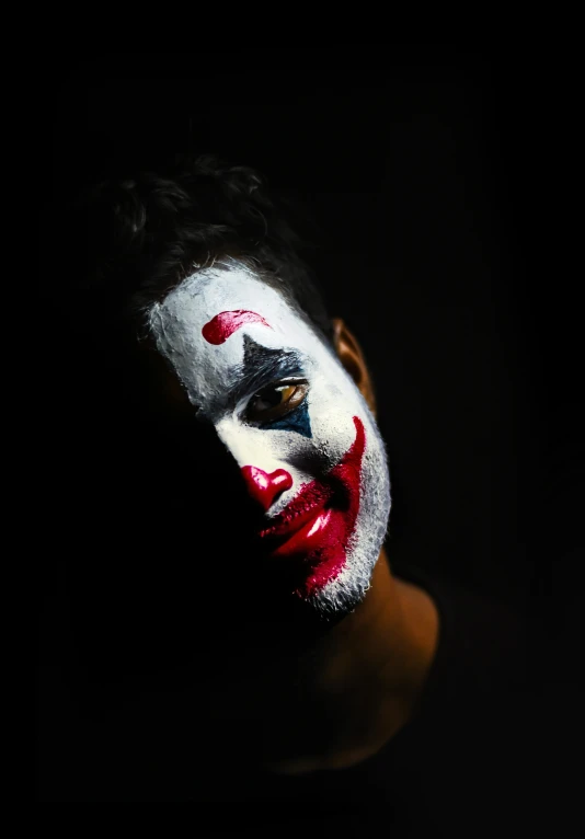 a man with face paint and a clown make up
