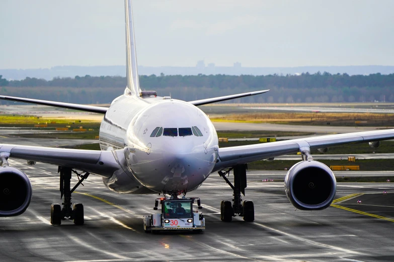 a white airplane is taking off from the runway