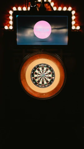 darts on top of a game board with neon lights