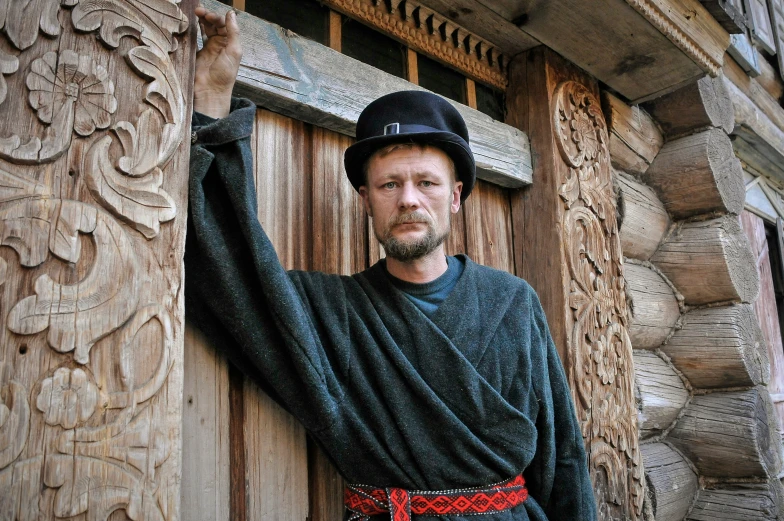 an old man standing outside next to a building