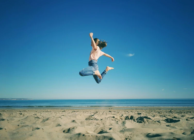 a boy that is jumping in the air with his skateboard