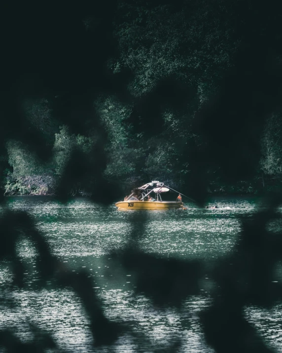 a yellow boat floating on top of a lake