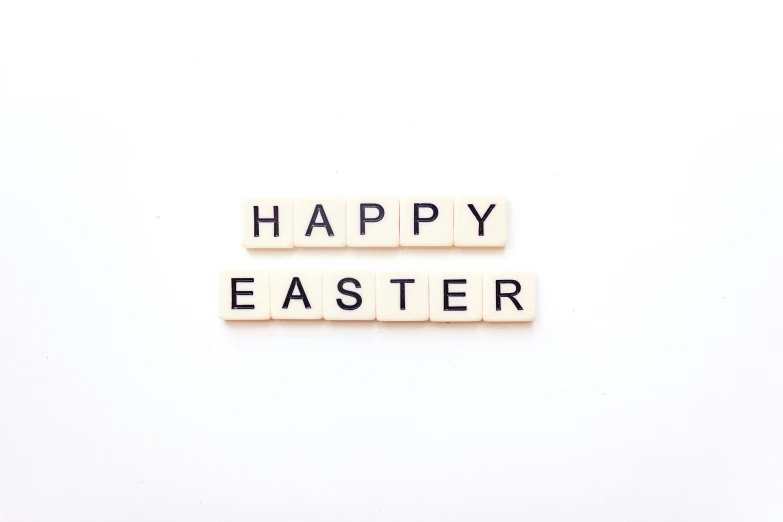 the scrabble spelling that says happy easter is arranged on the opposite side of scrabbles