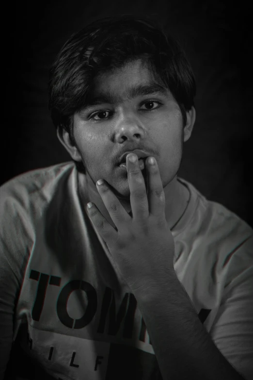 black and white po of man making hand gesture