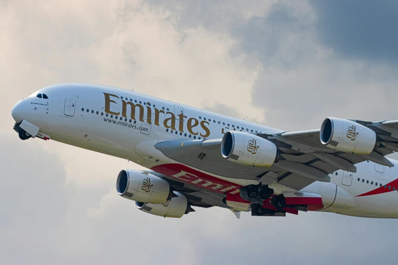 a large passenger jet flying through a cloudy sky