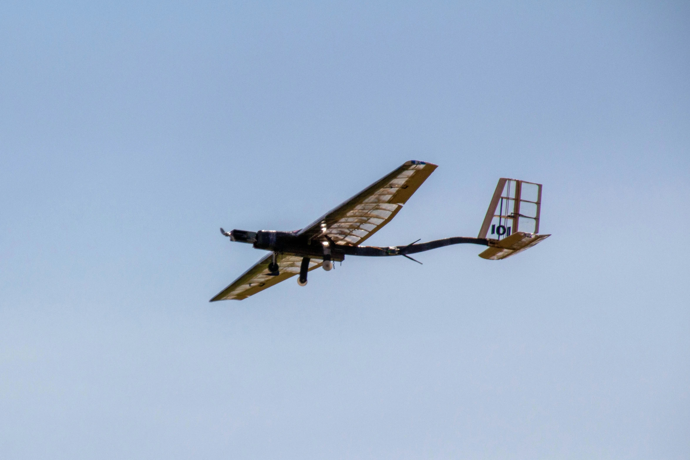 an old style plane flying through the sky