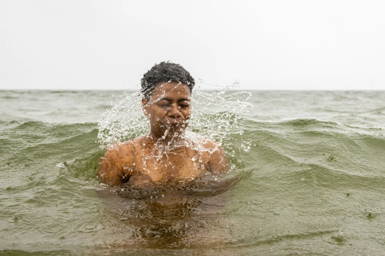 a person splashing water while swimming in the ocean