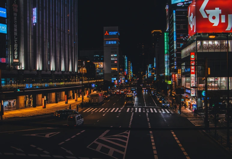 people are walking through an empty city at night