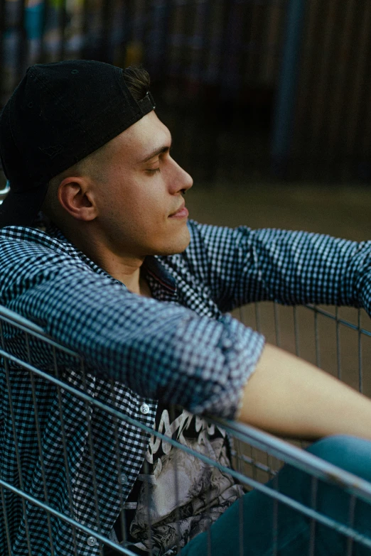 a person leaning against a shopping cart