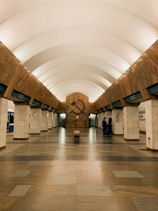 a hallway that has tile floors and stone walls