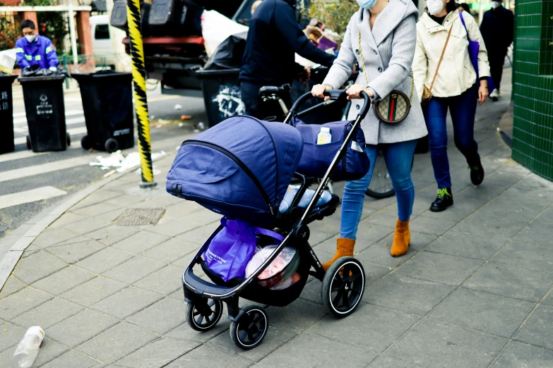 a woman hing a stroller with a child