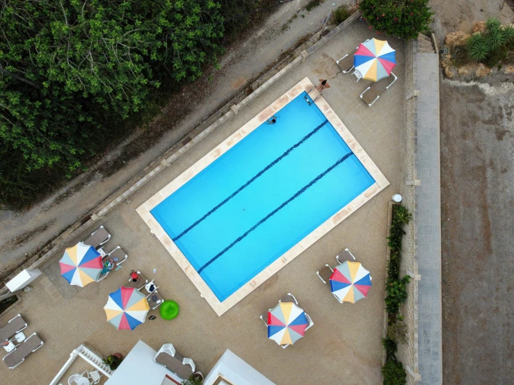 a large swimming pool with umbrellas over it