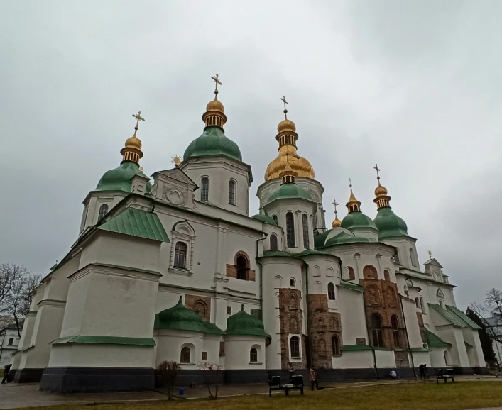 the church has many gold and green spires on its roof