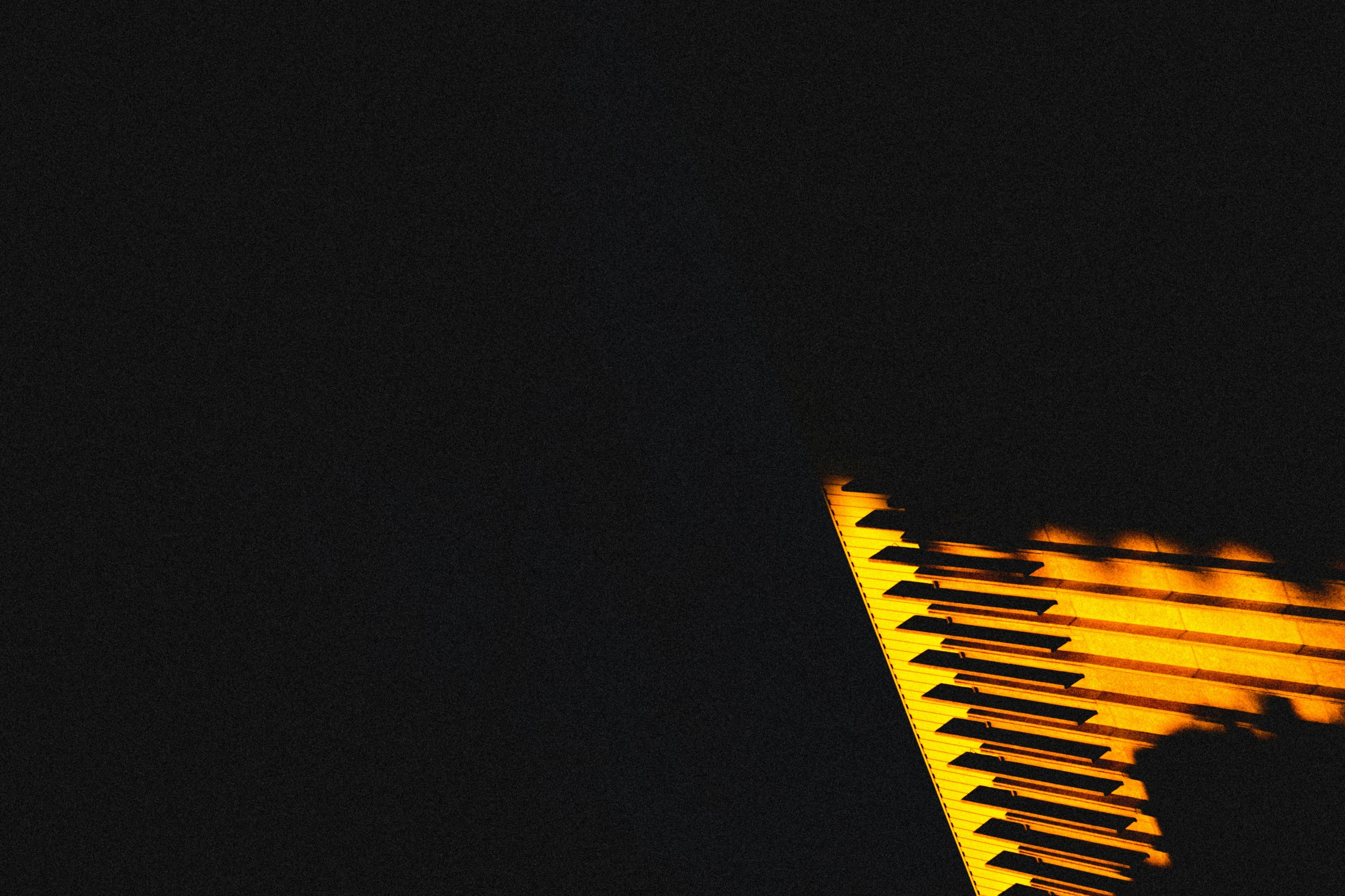 a close up of a yellow light shining through a triangle
