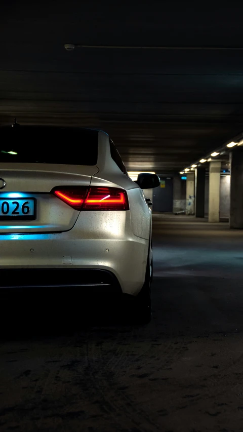 a white sports car is parked in a parking garage