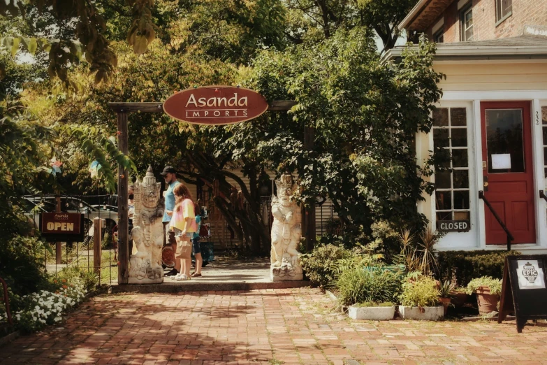 a store with an entrance way next to some flowers