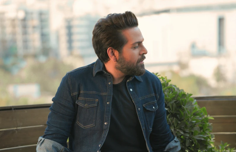 a man sitting down on a park bench