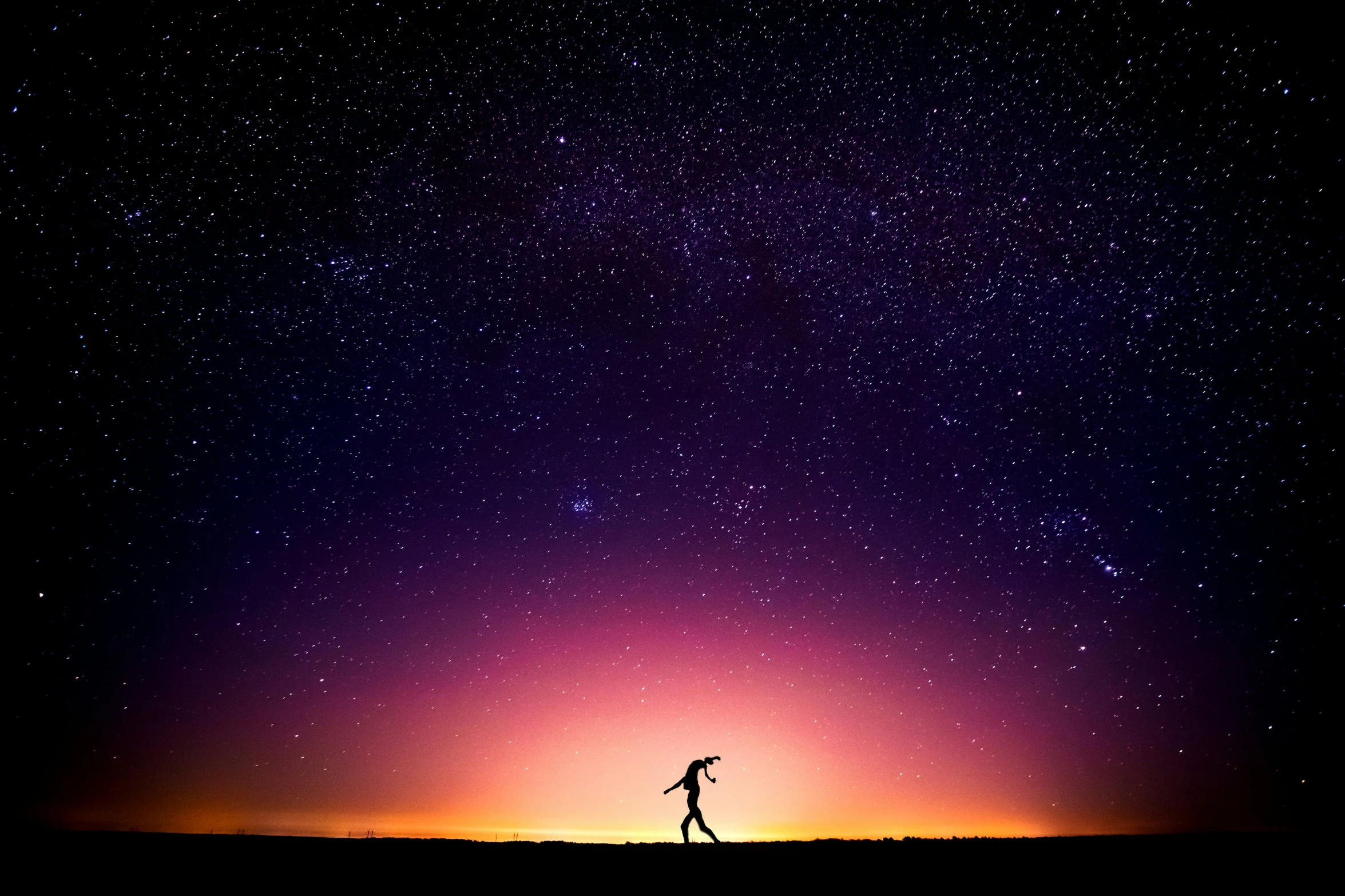 a lone person standing under the stars