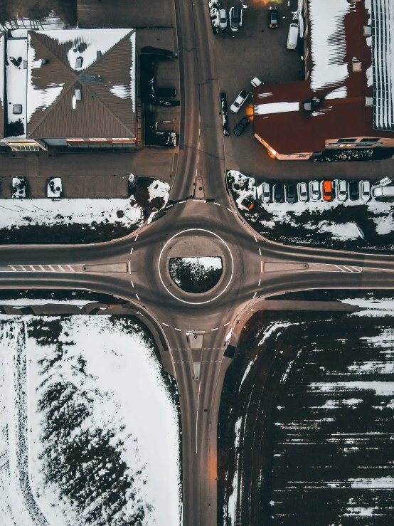 an aerial s of a road intersection with snow on the ground