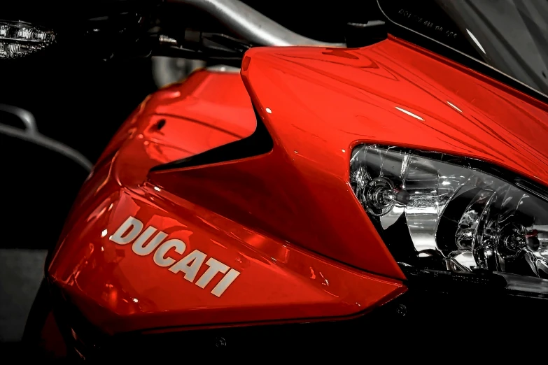 close up of red motorcycle with the word duc logo
