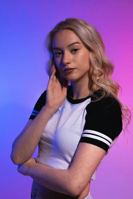 a woman standing on a pink and purple background