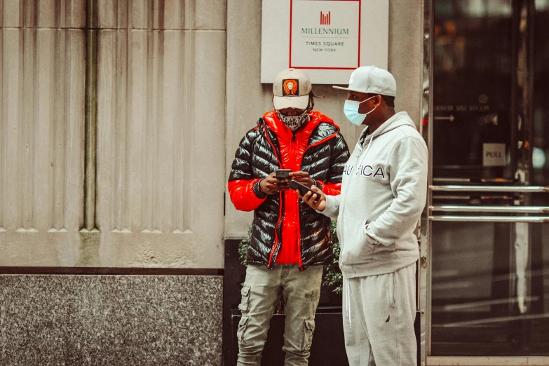 a couple of people are standing by a building