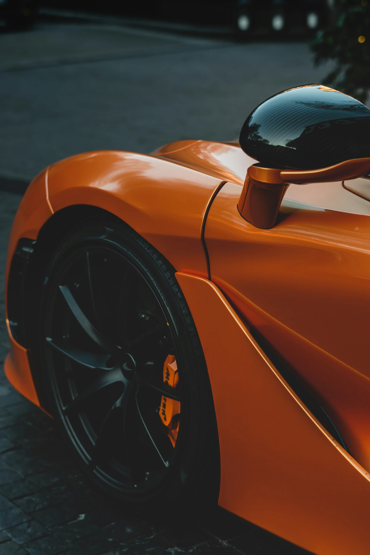 an orange sports car with a helmet mounted to it's roof