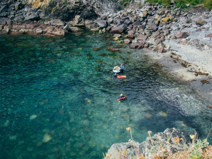 two people are paddle boarding in clear blue waters